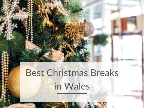 A gold and white decorated Christmas tree with text overlay saying Best Christmas Breaks in Wales